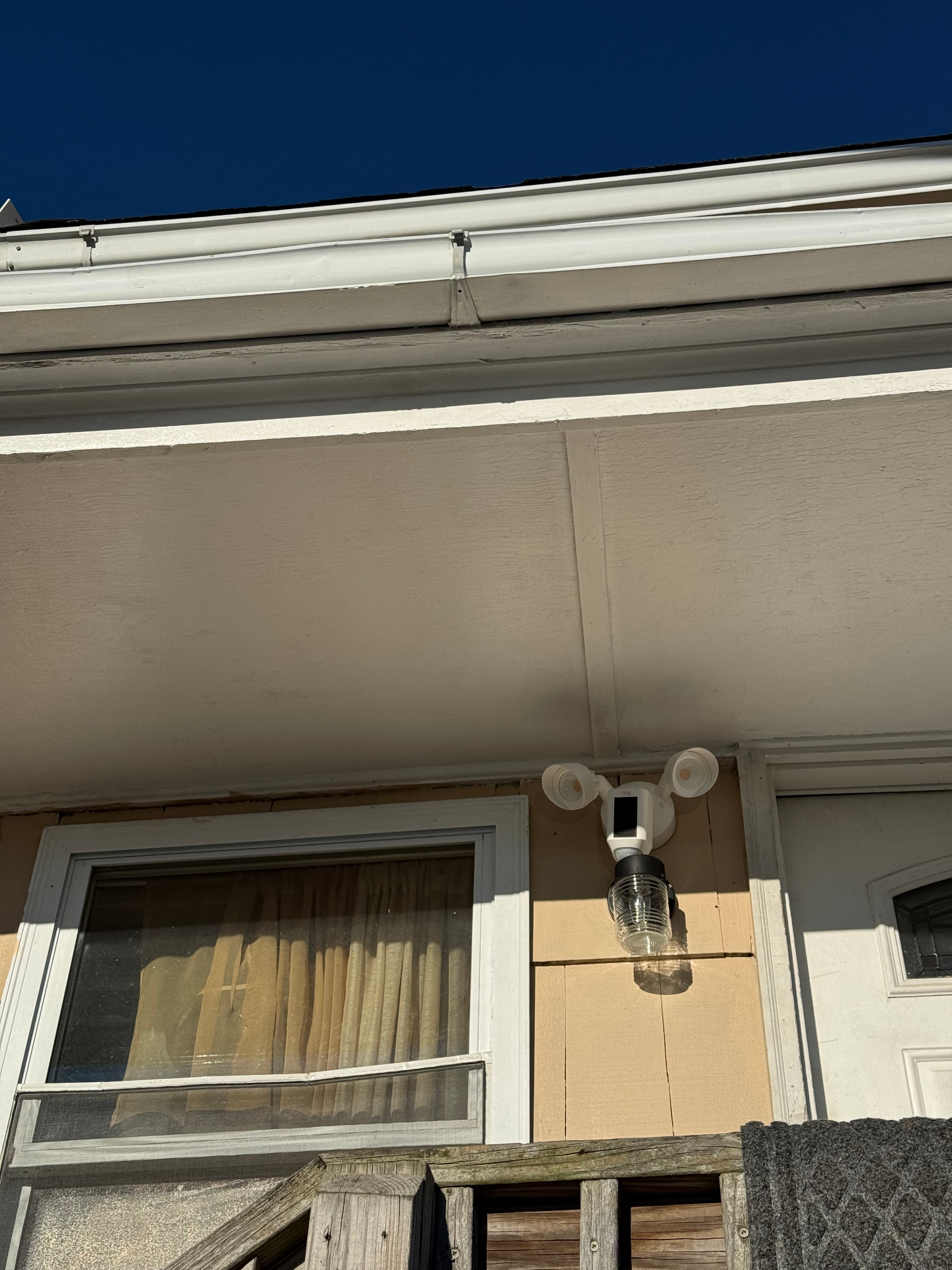 Residential floodlight security camera installed under home eaves in South Jersey